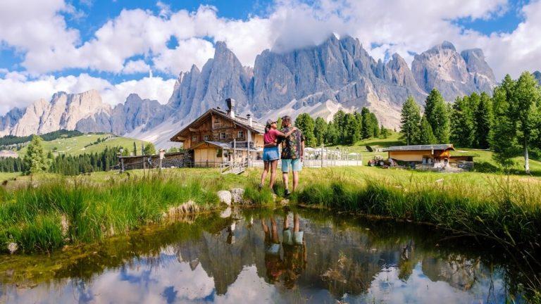 Geisleralm Rifugio Odle Dolomites Italy, men and woman hiking in the mountains of Val Di Funes in Italian Dolomites Adolf Munkel Trail in Puez Odle Nature Park